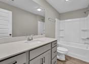 Thumbnail 16 of 36 - a bathroom with a sink and a toilet and a shower