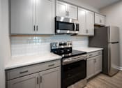 Thumbnail 22 of 36 - a kitchen with stainless steel appliances and white cabinets