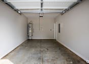 Thumbnail 29 of 36 - the inside of a garage with a concrete floor and white walls
