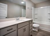 Thumbnail 30 of 36 - a bathroom with a sink toilet and a mirror