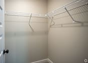 Thumbnail 34 of 36 - a walk in closet with empty shelves and a door