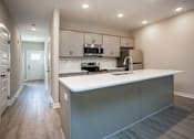 Thumbnail 25 of 36 - a kitchen with a white counter top and a sink