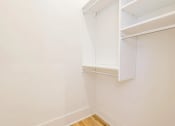 Thumbnail 3 of 19 - a small closet with white walls and white shelves