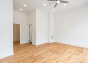 Thumbnail 13 of 19 - a bedroom with hardwood floors and white walls