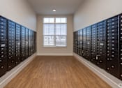 Thumbnail 21 of 39 - A room with a window and a row of mailboxes on the wall.