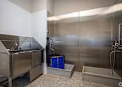 Thumbnail 17 of 39 - A stainless steel kitchen with a sink and a blue container.