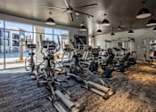 Thumbnail 6 of 39 - A gym with a variety of exercise equipment.