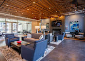 Thumbnail 8 of 39 - A living room with a fireplace and a television.