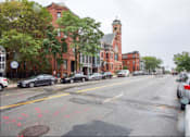 Thumbnail 9 of 9 - a city street with cars parked on the side of the road