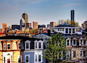 Thumbnail 7 of 9 - a city skyline with a row of houses in the foreground