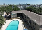 Thumbnail 20 of 23 - an aerial view of an apartment building with a swimming pool