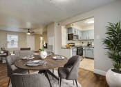 Thumbnail 4 of 23 - an open kitchen and dining area with a table and chairs