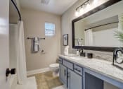 Thumbnail 10 of 23 - a bathroom with a toilet and a sink and a mirror