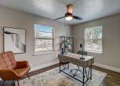 Thumbnail 15 of 23 - a home office with a desk and a ceiling fan