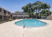 Thumbnail 22 of 23 - a resort style pool is next to an apartment building