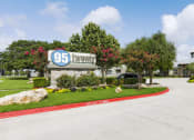 Thumbnail 14 of 14 - a driveway leading to a building with a sign that says 95 laurel