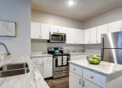 Thumbnail 3 of 42 - our apartments have a modern kitchen with stainless steel appliances