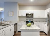 Thumbnail 4 of 42 - a kitchen with white cabinets and stainless steel appliances