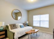 Thumbnail 5 of 42 - a bedroom with beige walls and a large window
