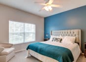 Thumbnail 6 of 42 - a bedroom with a bed and a ceiling fan