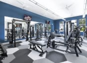 Thumbnail 8 of 14 - a workout room with exercise equipment and a flat screen tv