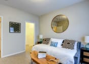 Thumbnail 7 of 42 - a bedroom with a bed and a table in front of it