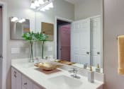 Thumbnail 8 of 42 - a bathroom with a sink and a mirror