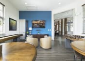 Thumbnail 10 of 14 - a common area with tables and chairs and a foosball table