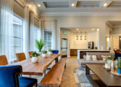 Thumbnail 10 of 42 - a large living room with a long wooden table and chairs