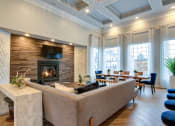 Thumbnail 11 of 42 - a living room with a fireplace and a dining room in the background