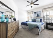 Thumbnail 4 of 14 - a bedroom with a bed and a ceiling fan