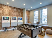 Thumbnail 13 of 42 - a games room with a foosball table and three arcade games