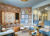 Thumbnail 15 of 42 - a living room with a large screen tv on the wall