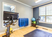 Thumbnail 18 of 42 - a home gym with exercise bikes and a tv