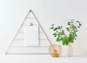 Thumbnail 21 of 42 - a white wall with a white vase with a green plant