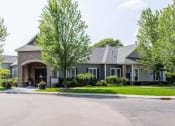 Thumbnail 31 of 42 - a house with a driveway and trees in front of it