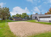 Thumbnail 38 of 42 - a house with a volleyball court in front of it