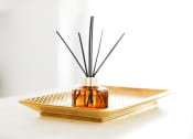 Thumbnail 41 of 42 - a diffuser sitting on a tray with a black reed diffuser on top of it