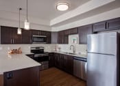Thumbnail 14 of 47 - a kitchen with stainless steel appliances and a white counter top
