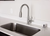 Thumbnail 20 of 47 - a kitchen sink with a chrome faucet