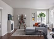 Thumbnail 18 of 47 - a living room with a fireplace and a couch