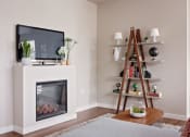 Thumbnail 19 of 47 - a living room with a fireplace and a television
