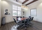 Thumbnail 12 of 23 - A conference room with a large table and chairs at 95twenty Apartments, Austin, TX, 78717