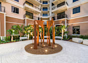 Thumbnail 25 of 25 - A large sculpture in the middle of a courtyard surrounded by benches and plants.
