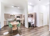 Thumbnail 3 of 25 - A modern kitchen with a dining table set for two.