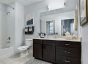Thumbnail 4 of 23 - a bathroom with a toilet sink mirror and shower in a 555 waverly unit