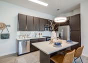 Thumbnail 1 of 23 - a kitchen with a large island and stainless steel appliances