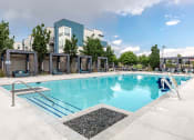 Thumbnail 10 of 23 - a swimming pool with a building in the background