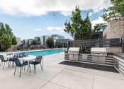 Thumbnail 21 of 23 - a swimming pool with a table and chairs next to it