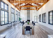 Thumbnail 19 of 41 - Resident lounge and co-working space with a long wooden table and chairs. at Barton Creek Villas, Austin, Texas